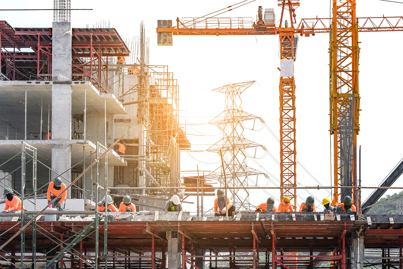Workers are working on large construction sites and many cranes Workers are working on large construction sites and many cranes
